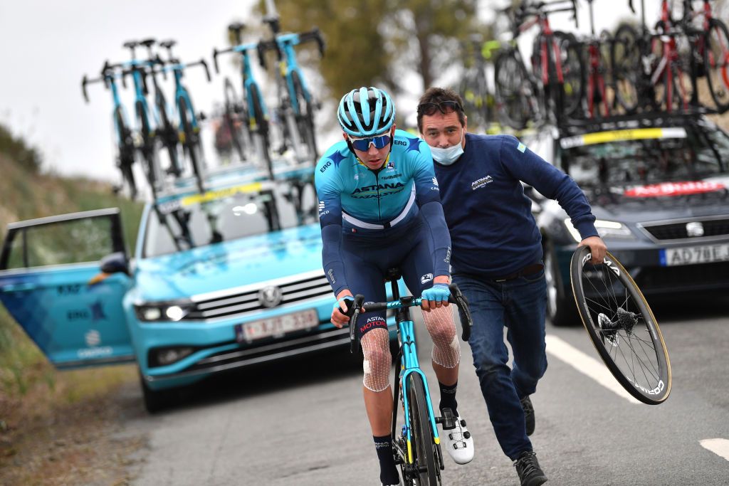 FARO PORTUGAL FEBRUARY 18 Joseph Lloyd Dombrowski of United States and Team Astana Qazaqstan changes a flat tire during the 48th Volta Ao Algarve 2022 Stage 3 a 2114km stage from Almodvar to Faro VAlgarve2022 on February 18 2022 in Faro Portugal Photo by Luc ClaessenGetty Images