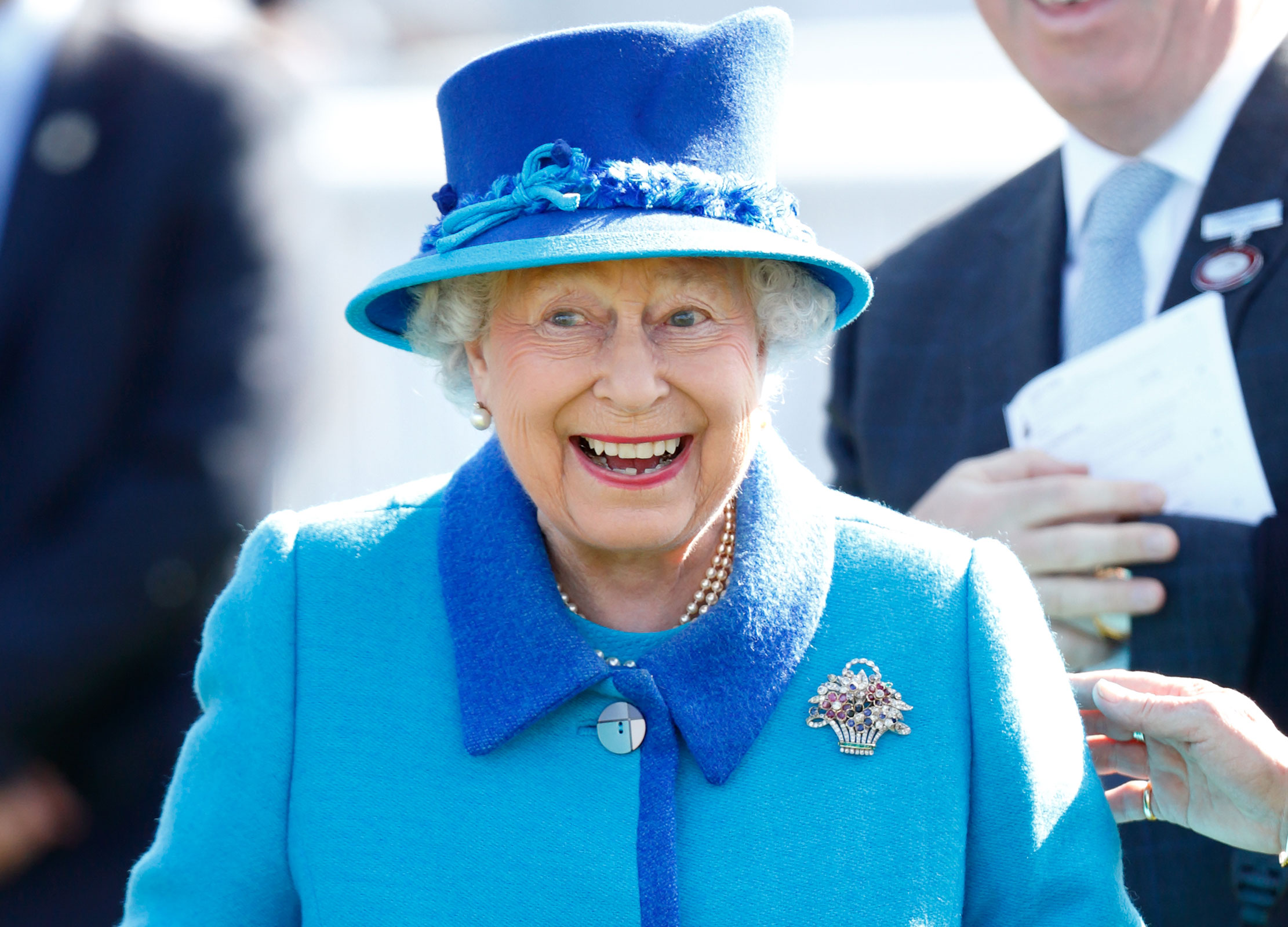 Never happier than when with a smile on her face at the races, Queen Elizabeth II is pictured here celebrating a win at Newbury races.