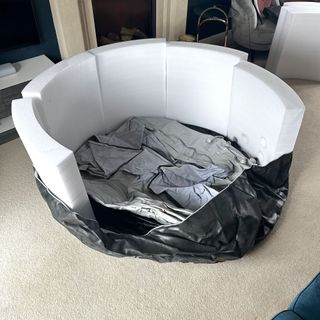 The Wave Osaka hot tub being assembled in a carpeted living room