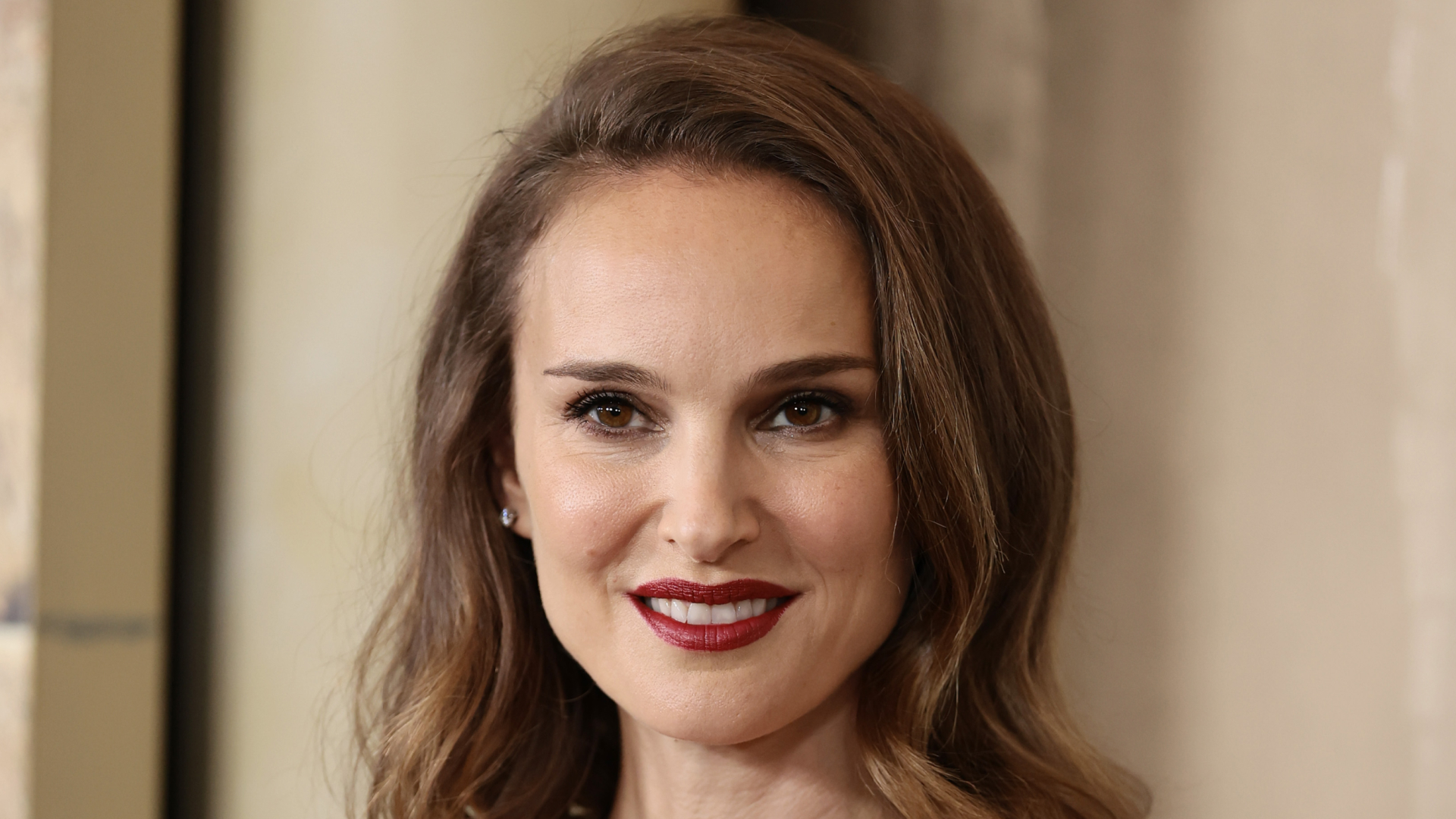 Natalie Portman wearing bold lipstick with a sidepart hairstyle