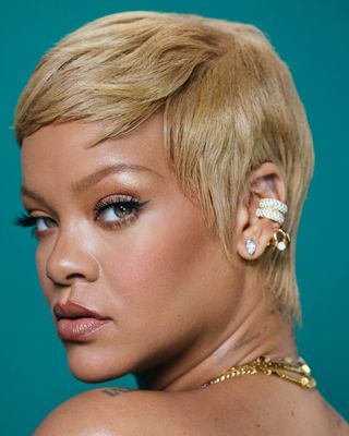 Side profile of Rihanna with teal background