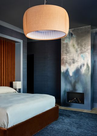 A bedroom with ethereal mural covered chimney breast