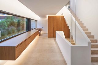 Internal view of Stone Clad Villa - stairs and wooden storage units