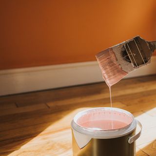 pink paint can with brush