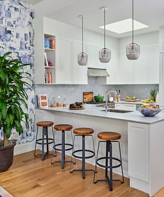 Pendant light, wooden stools, white cabinets