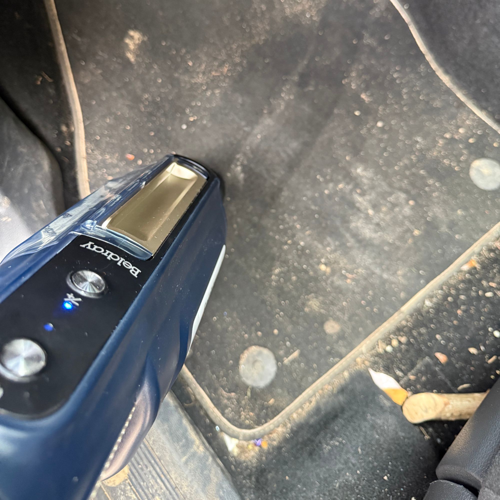 Using the Beldray handheld attachment on dirty car mats