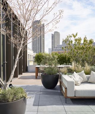 Urban city garden idea with white furniture and plenty of plants