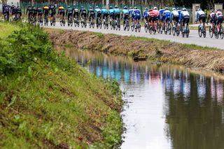 The Giro d'Italia peloton rides on the flat roads of stage 13