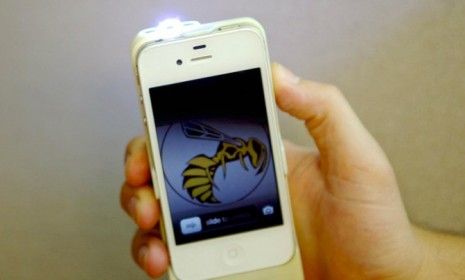 A prototype of the Yellow Jacket stun gun in action: The iphone doubles as a 650,000-volt weapon at your ready should a surprise attack happen.