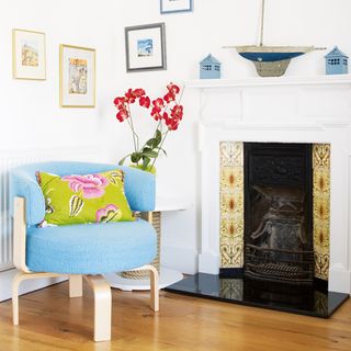 sitting room with blue chair and fire place