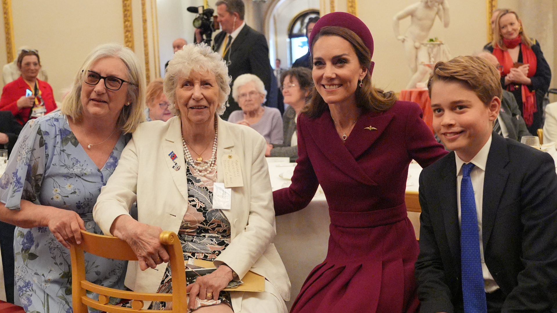 Prince George posing with his mom Kate Middleton and two women at a tea party
