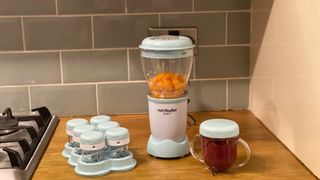 Nutribullet Baby on a kitchen countertop with extra storage pots