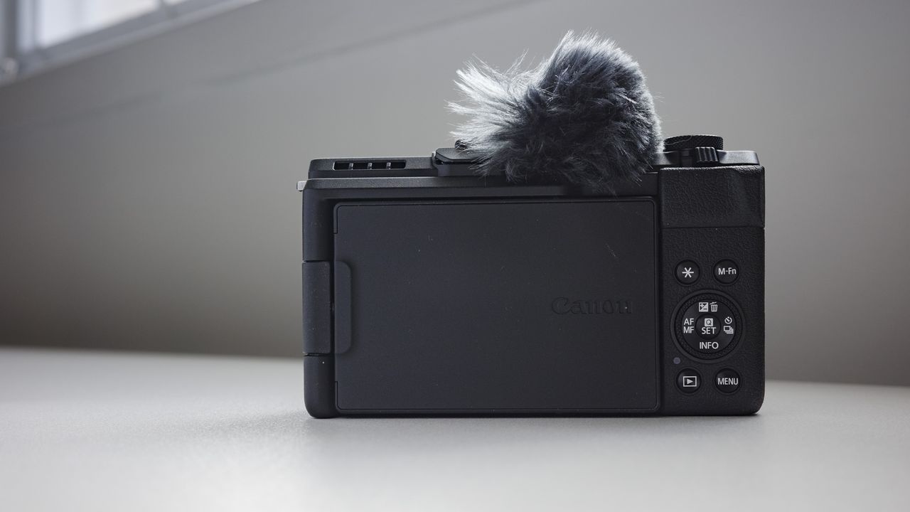 Rear of the Canon PowerShot V1 compact vlogging camera on a white desk