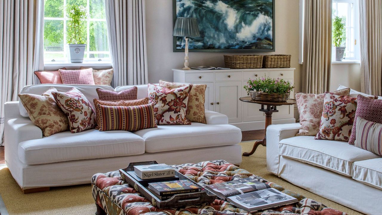 white colour living room with sofa set and cupboard.