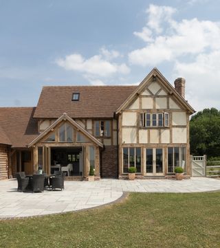 oak frame self build with grey patio and brick edge detail