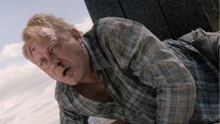 Stellan Skarsgard lies on the ground while enchanted in The Avengers.