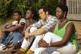 A sad-looking Neville (Ralf Little) sits on the beach outside his hut, joined by his off-duty colleagues Marlon (Tahj Miles), Naomi (Shantol Jackson) and Darlene (Ginny Holder)