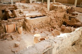 Akrotiri is an archaeological site from the Minoan Bronze Age on the Greek island of Santorini (Thera). Photo of recovered aincient buildings and decorated pottery.