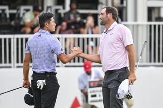 Collin Morikawa and Scottie Scheffler shake hands on the 18th green at East Lake