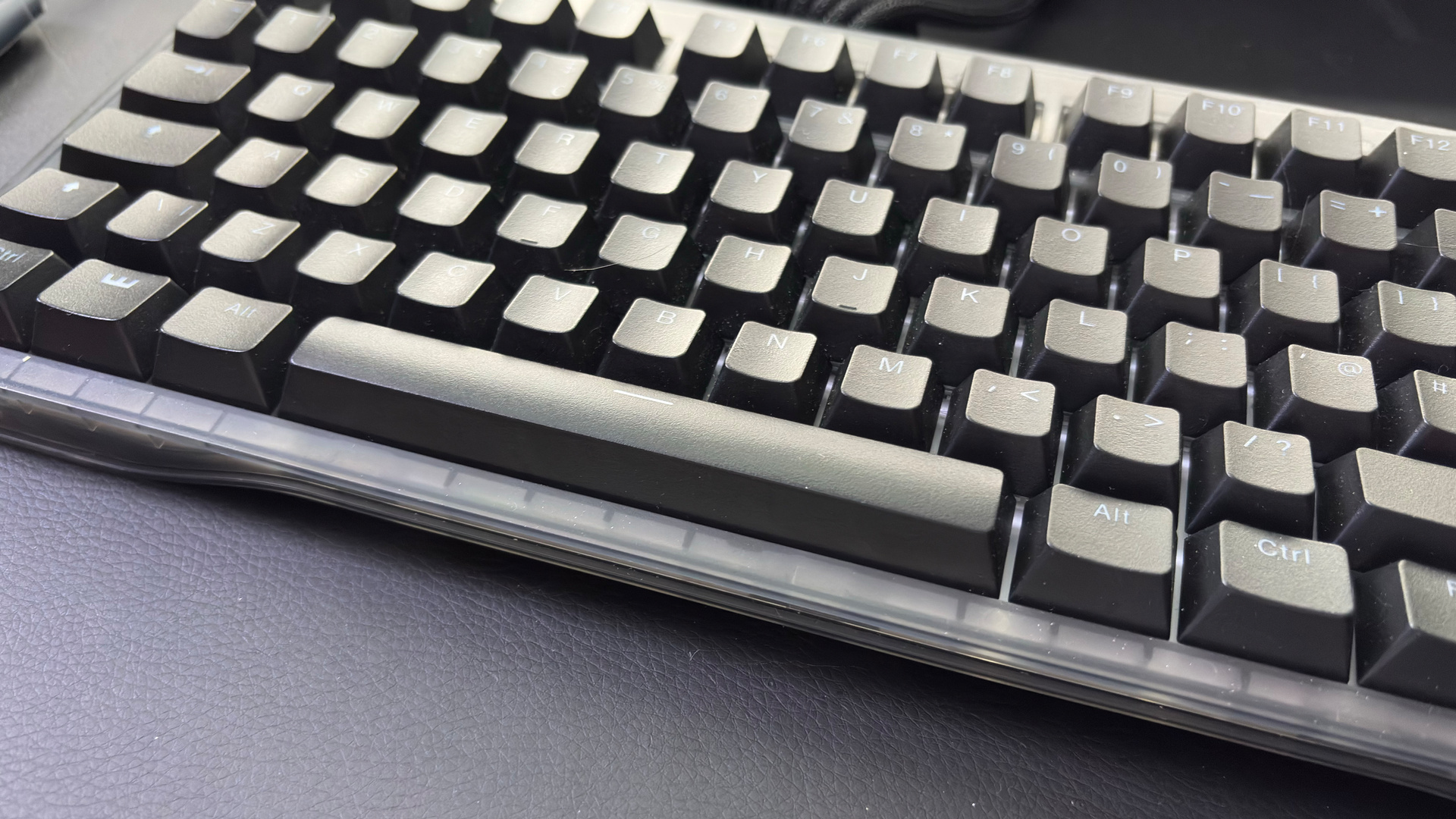 The Wooting 60HE v2 with a split spacebar on a desk alongside the Wooting 80HE with a normal spacebar.