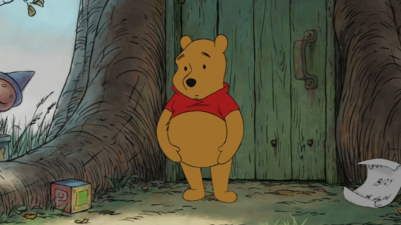 Winnie the Pooh looking mildly surprised while holding his belly