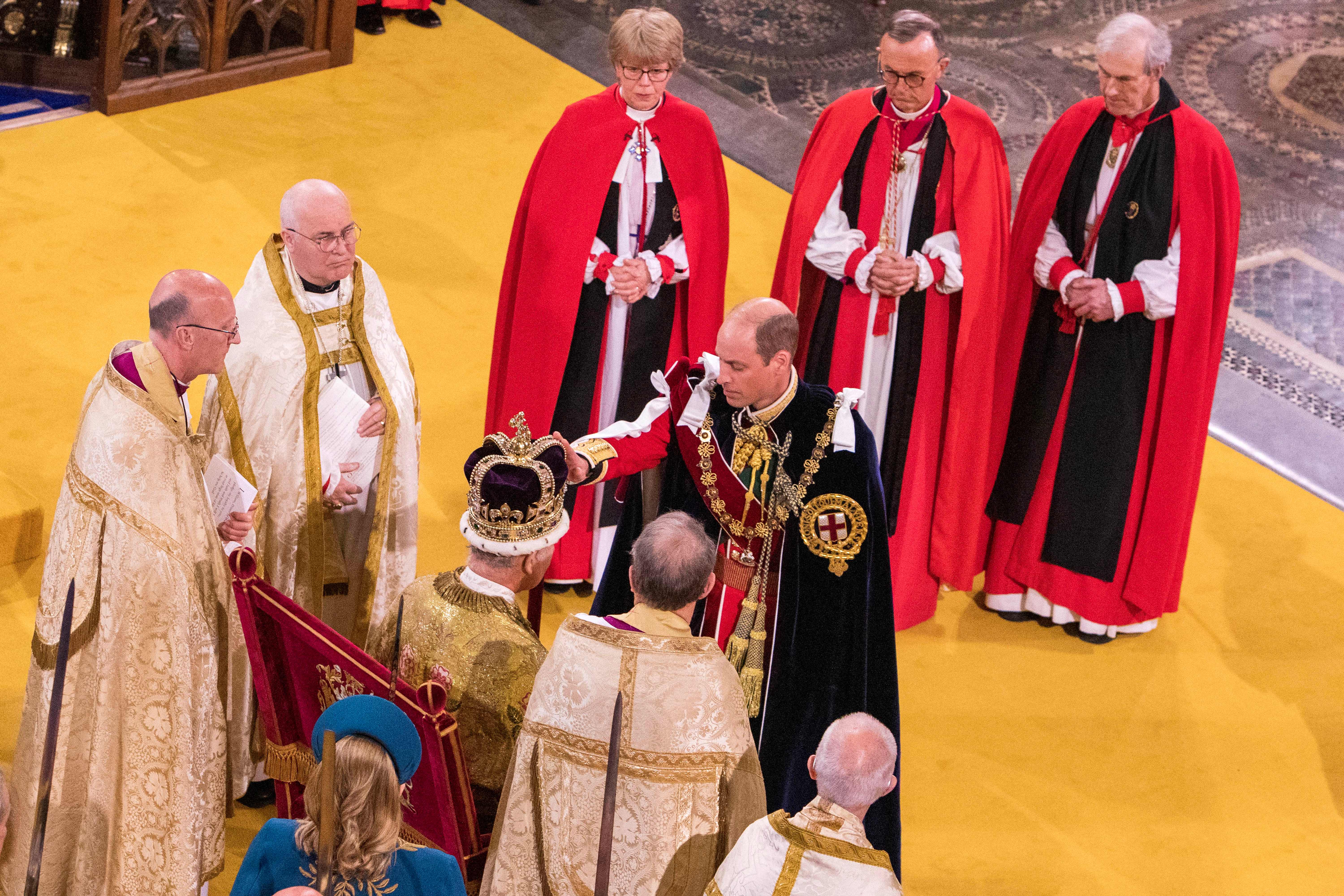 Prince William touching King Charles's crown at his coronation