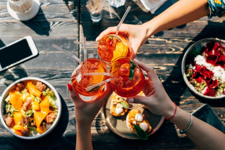Aperol Spritz cocktails and food on a table