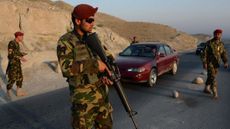 Afghan soldiers keep watch at a checkpoint in Nangarhar province 