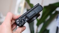 Canon PowerShot SX740 HS compact camera held in a hand