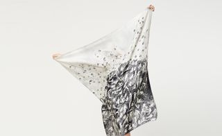 A black and white printed scarf being help open