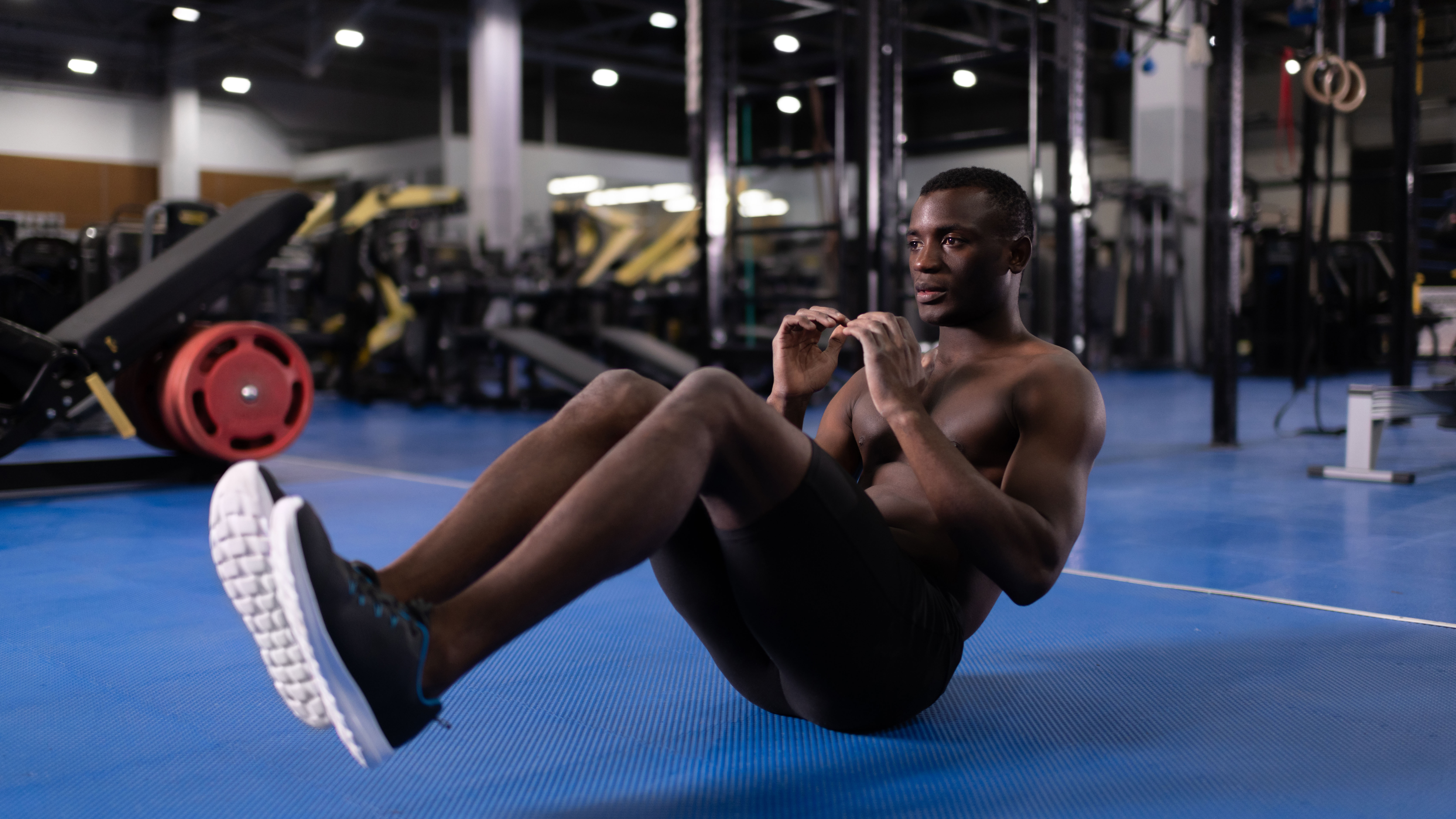 Man exercising core muscles in gym