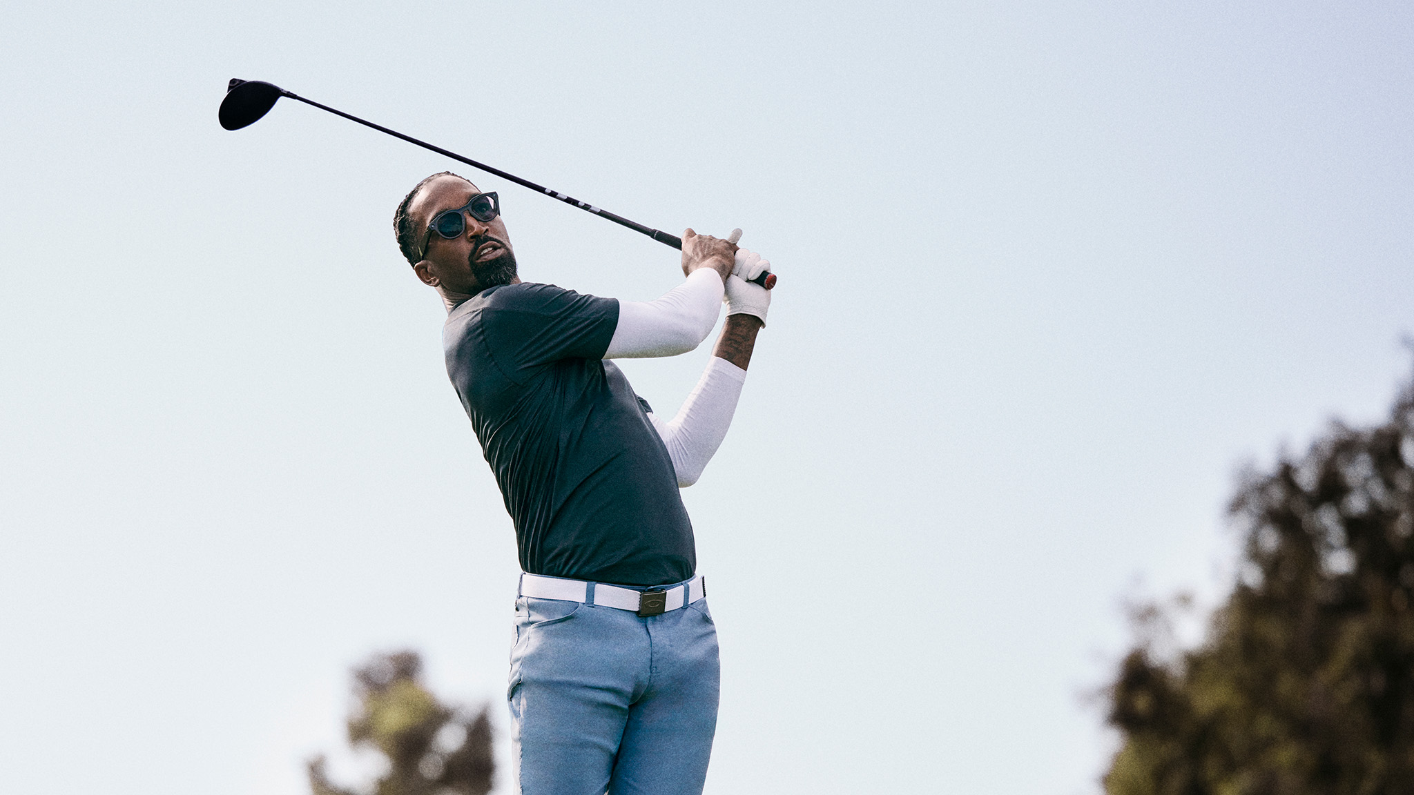 Official lifestyle shots of a person wearing Oakley Meta HSTN smart glasses