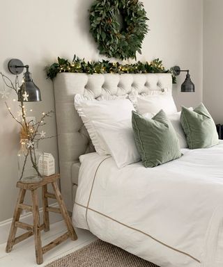 White bedding, grey bedhead, wreath and fairy lights