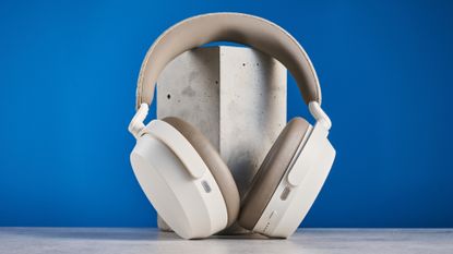 the sennheiser momentum 5 in white photographed against the blue tom's guide background