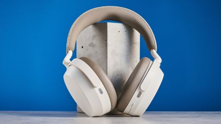 the sennheiser momentum 5 in white photographed against the blue tom's guide background