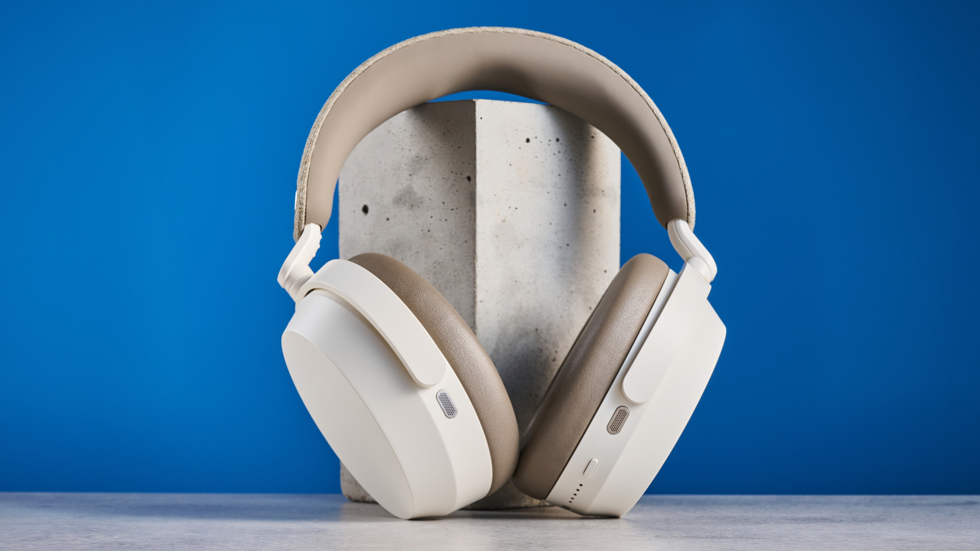 the sennheiser momentum 5 in white photographed against the blue tom's guide background