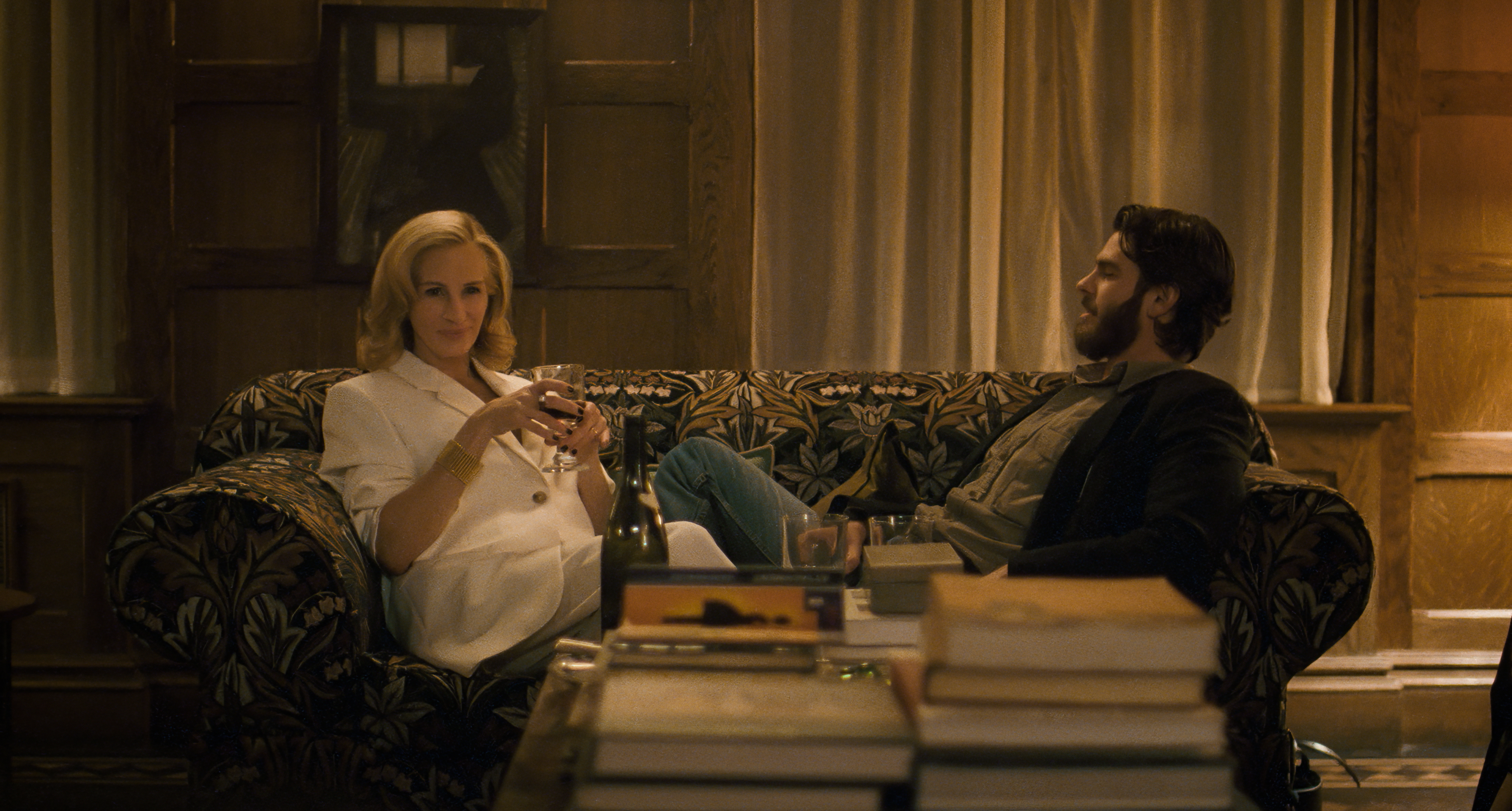 julia roberts as alma and andrew garfield as hank sitting on a couch together in after the hunt