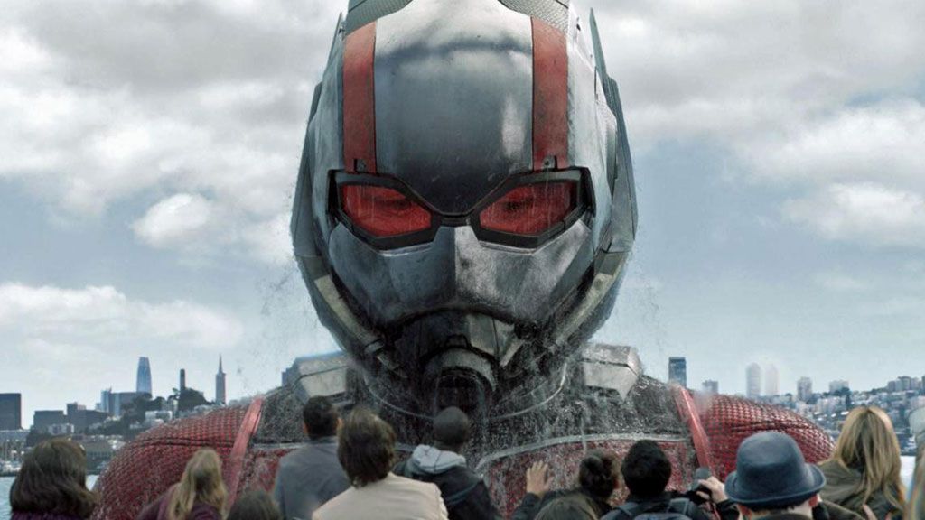 Ant-Man&#039;s giant form rises from a river as he looks over a ferry in Ant-Man and the Wasp