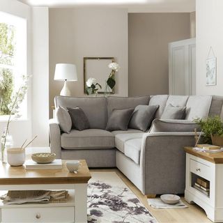 white living room with grey sofa and cushions