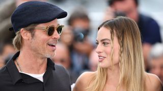 Brad Pitt and Margot Robbie standing together at an event.