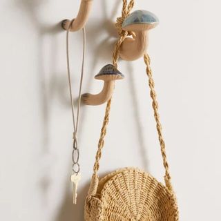 Mushroom wall hooks holding key and purse