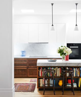 kitchen with stained oak cabinets, island, pendant lights and carrara marble worksurfaces designed by Sarah McPhee in Melbourne period house