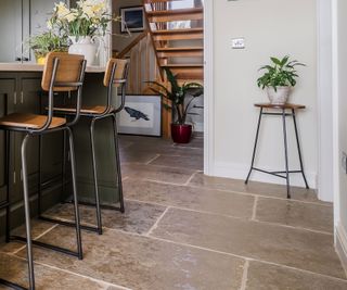 Green shaker kitchen with limestone flooring