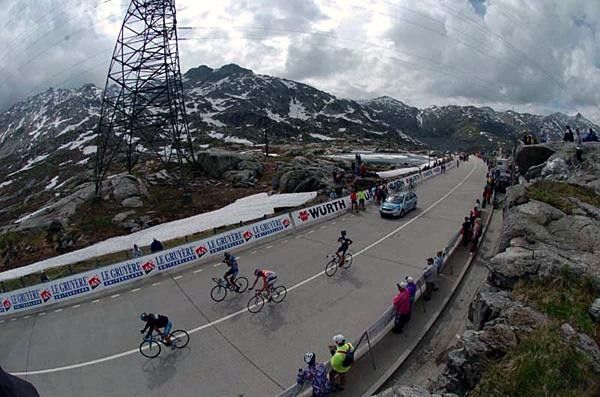 Riders cross the summit of the Gotthardpass