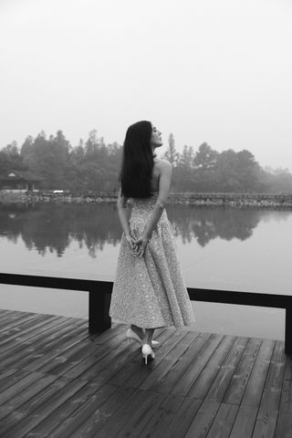 Orion Carlotto wears a chanel dress on a bridge while on her way to the Chanel show