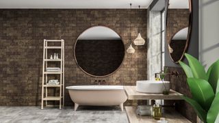 Interior of modern bathroom with brick walls, concrete floor, white bathtub with round mirror and white round sink standing on wooden shelf