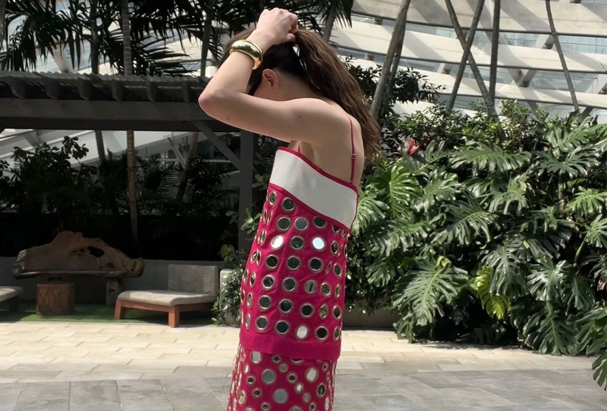 Eliza Huber wearing a pink mirrored Tory Burch dress.
