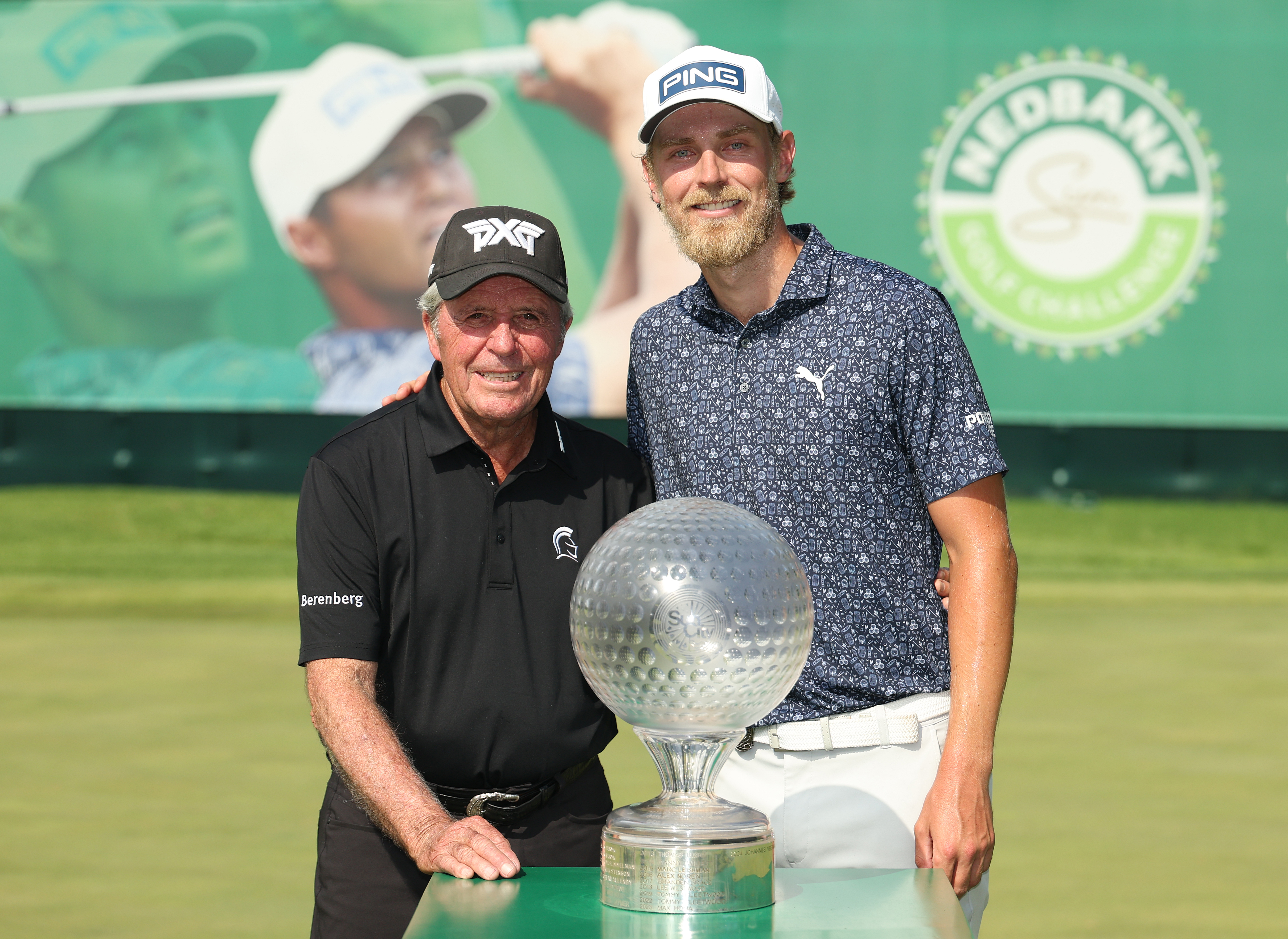 Gary Player and Kristoffer Reitan pose next to the Nedbank Golf Challenge trophy