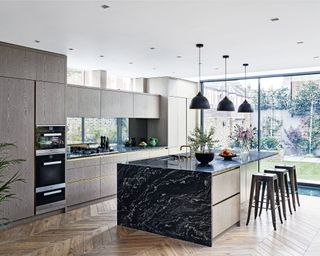Black granite island in a large, contemporary kitchen