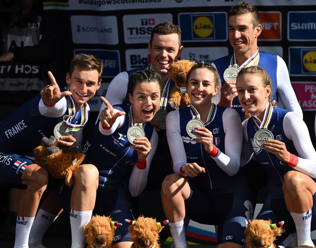 Riders from France celebrate with their silver medals and cow mascots after the Team Time Trial Mixed Relay road race during the UCI Cycling World Championships in Glasgow Scotland on August 8 2023 Switzerland won gold and Germany bronze Photo by Oli SCARFF AFP Photo by OLI SCARFFAFP via Getty Images
